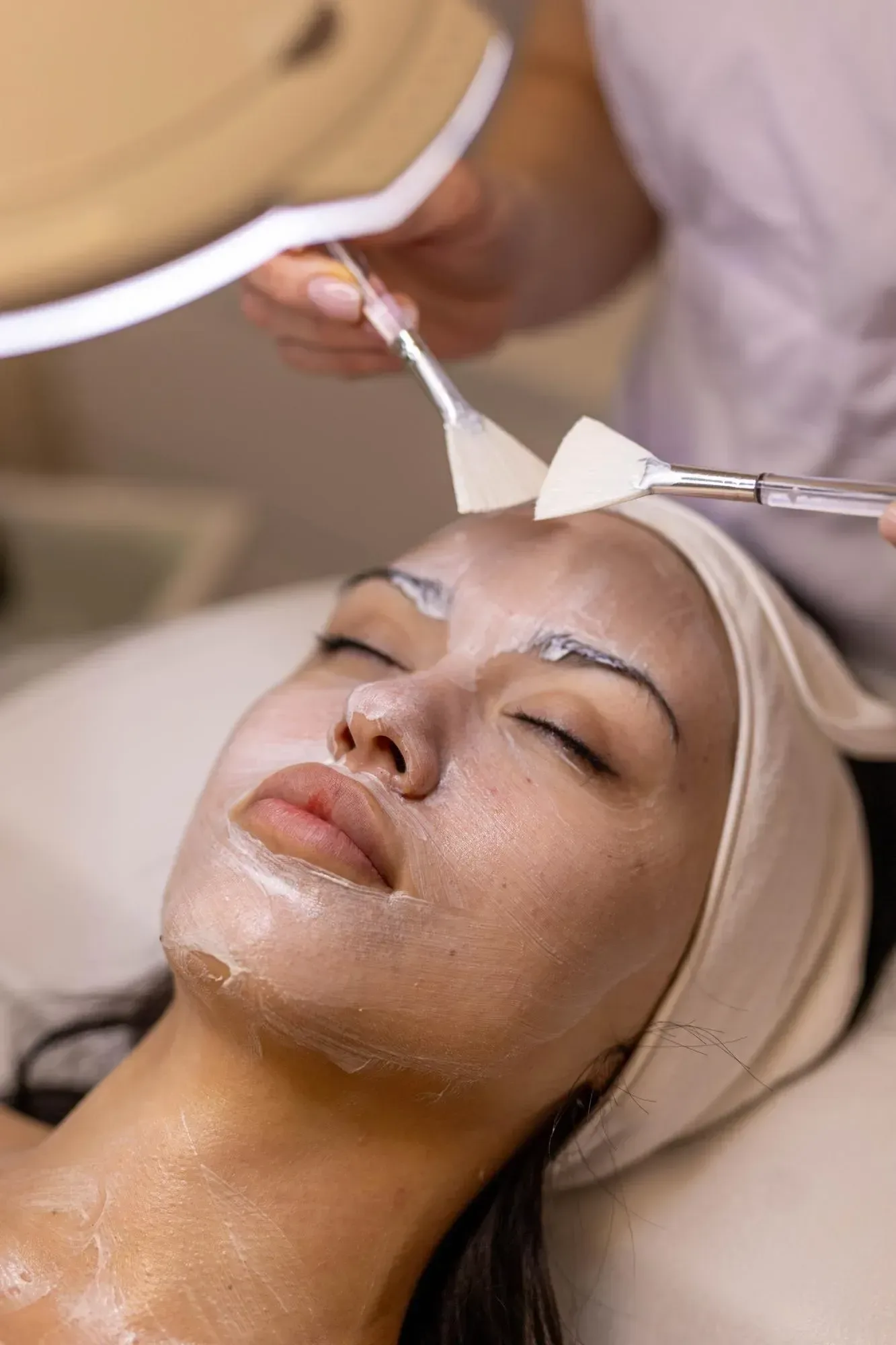 Soft abstract background of layered pink and plum tones suggesting fresh, renewed skin after a peel