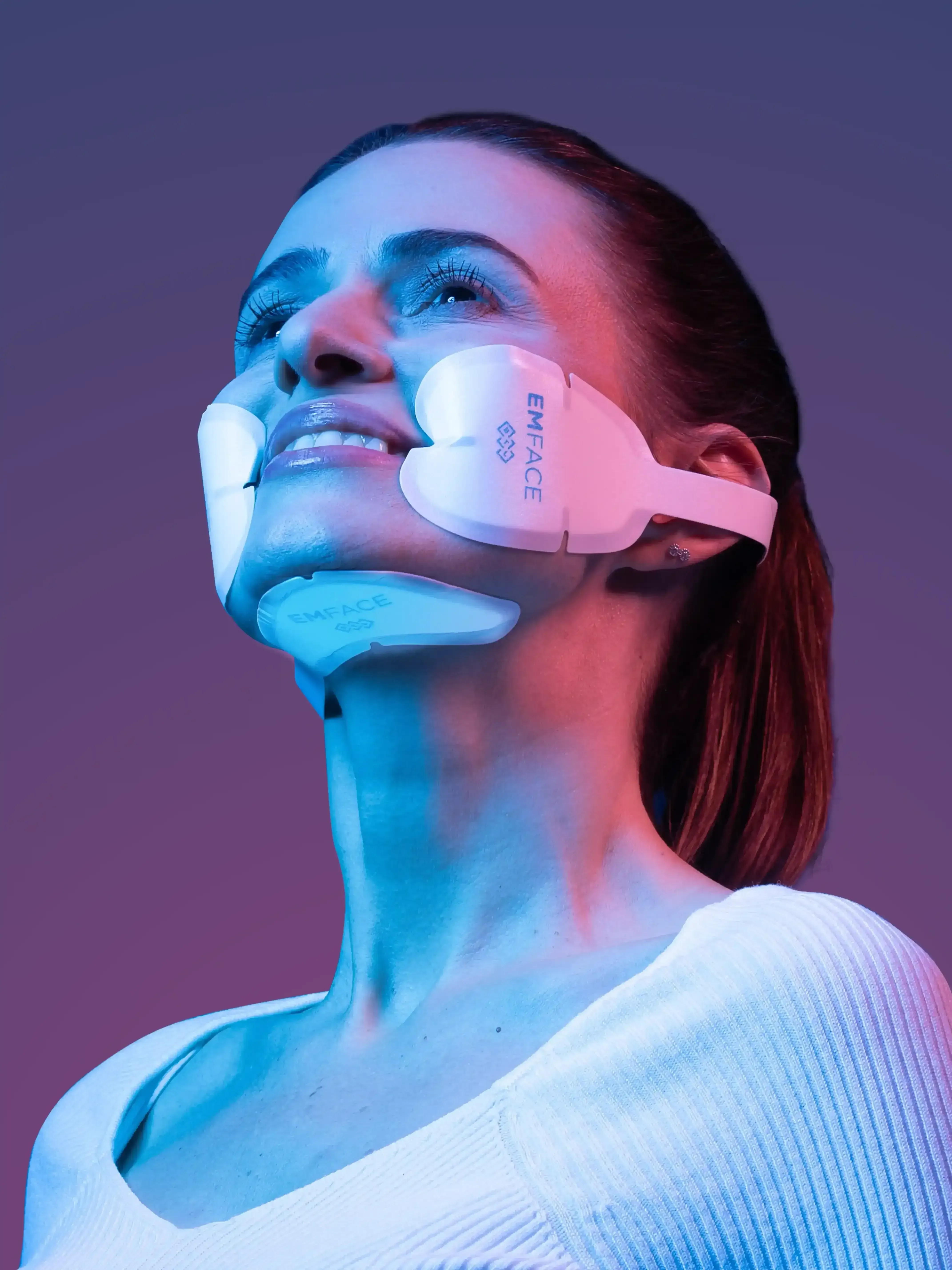 Soft magenta and plum gradient background used behind the Emface treatment areas at Applegate MedSpa