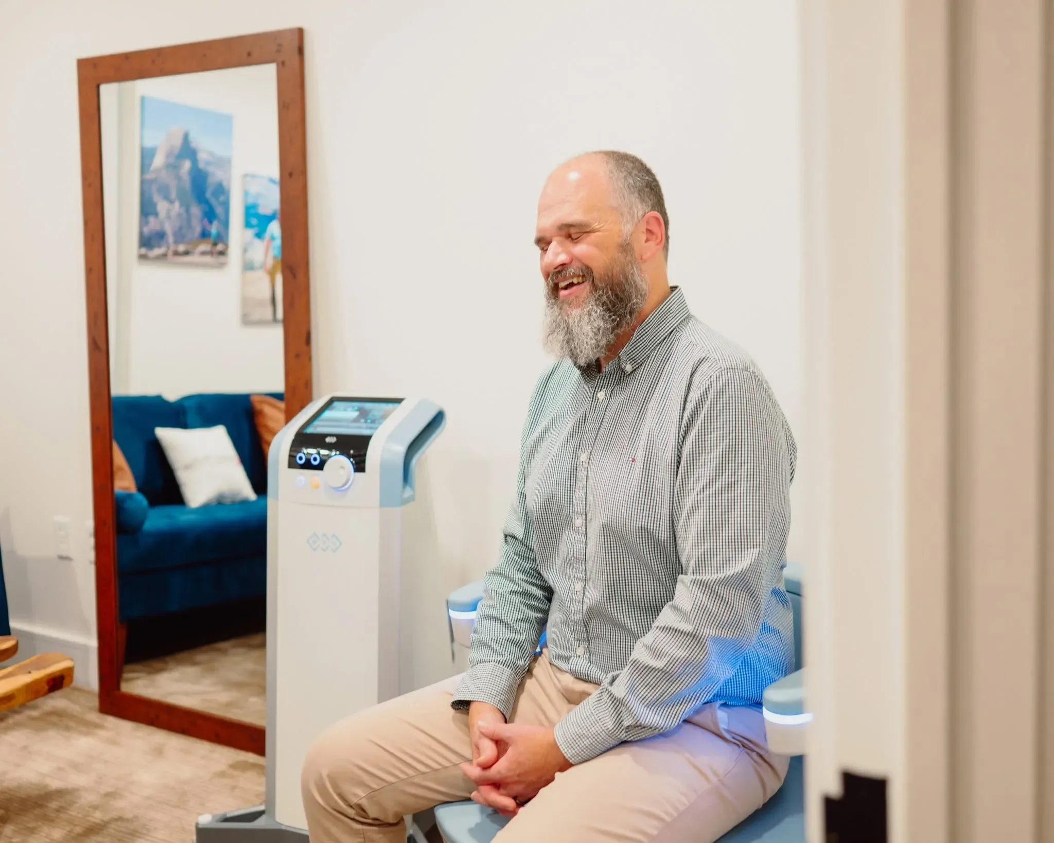 Woman seated fully clothed on the Emsella pelvic floor therapy chair at Applegate Dentistry and MedSpa in Covington, KY