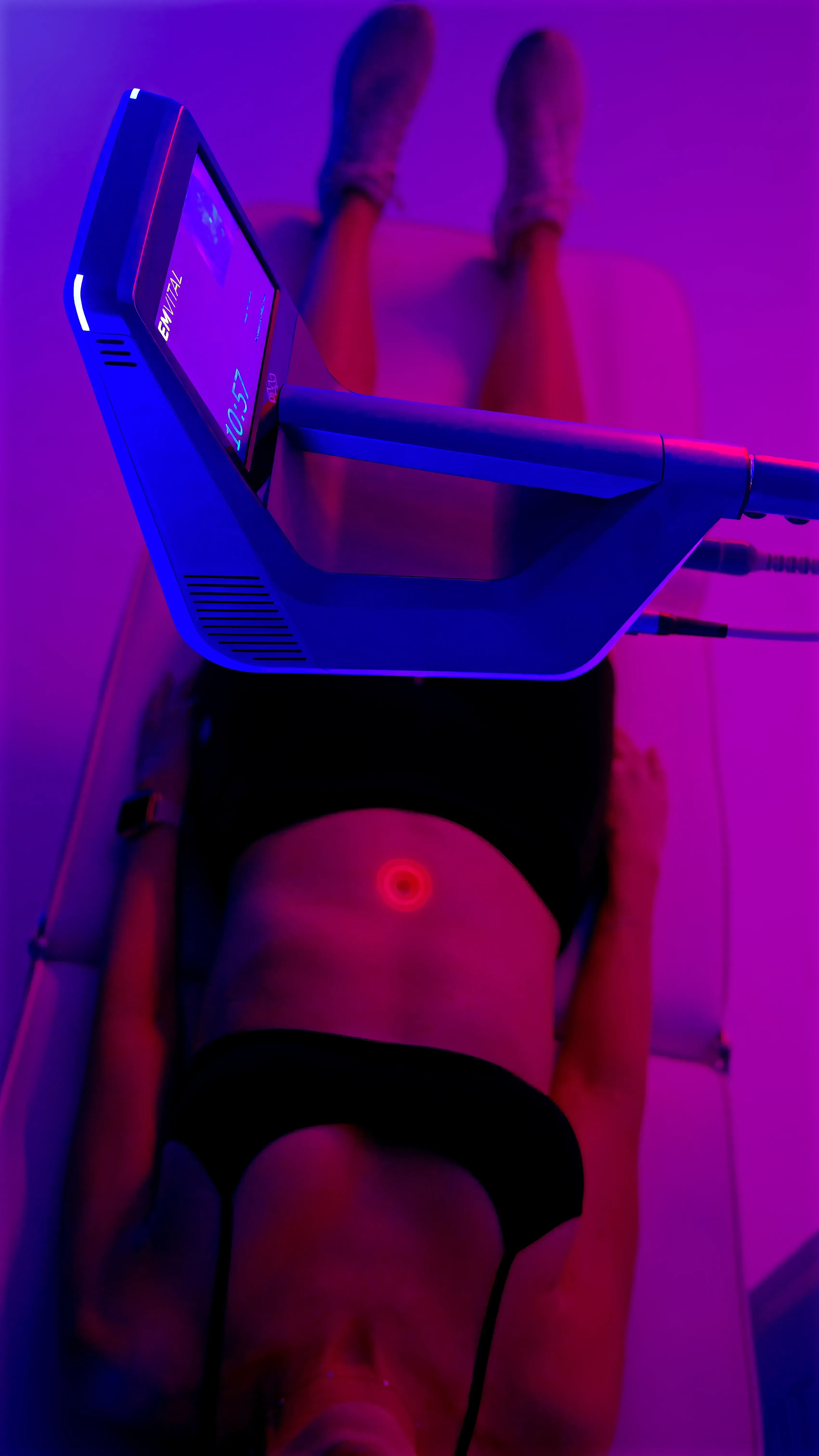 Soft magenta and plum gradient background suggesting warm laser light reaching deep muscle and joint tissue