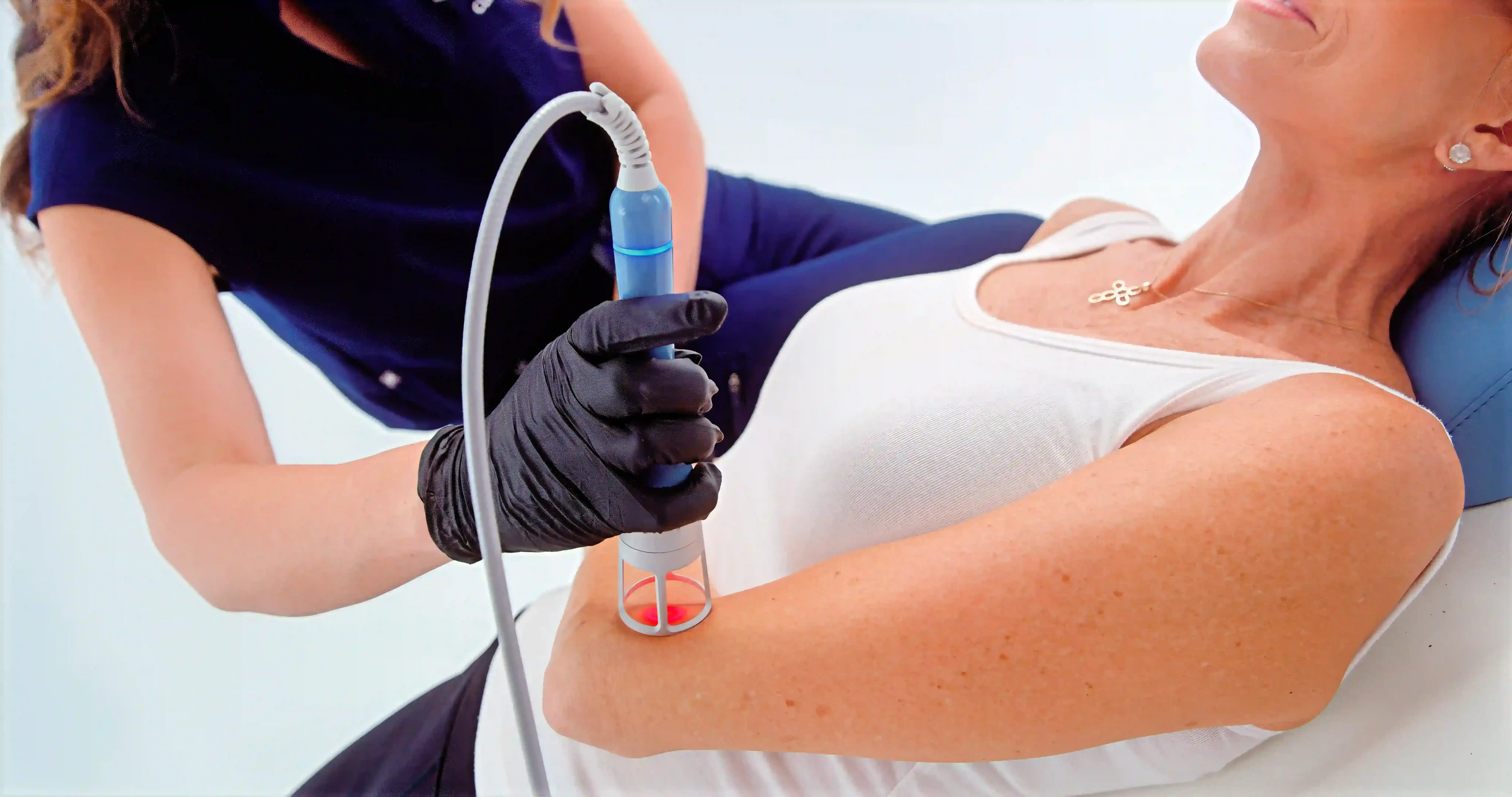 Patient receiving Emvital laser therapy for lower back pain at Applegate Dentistry and MedSpa in Covington, KY