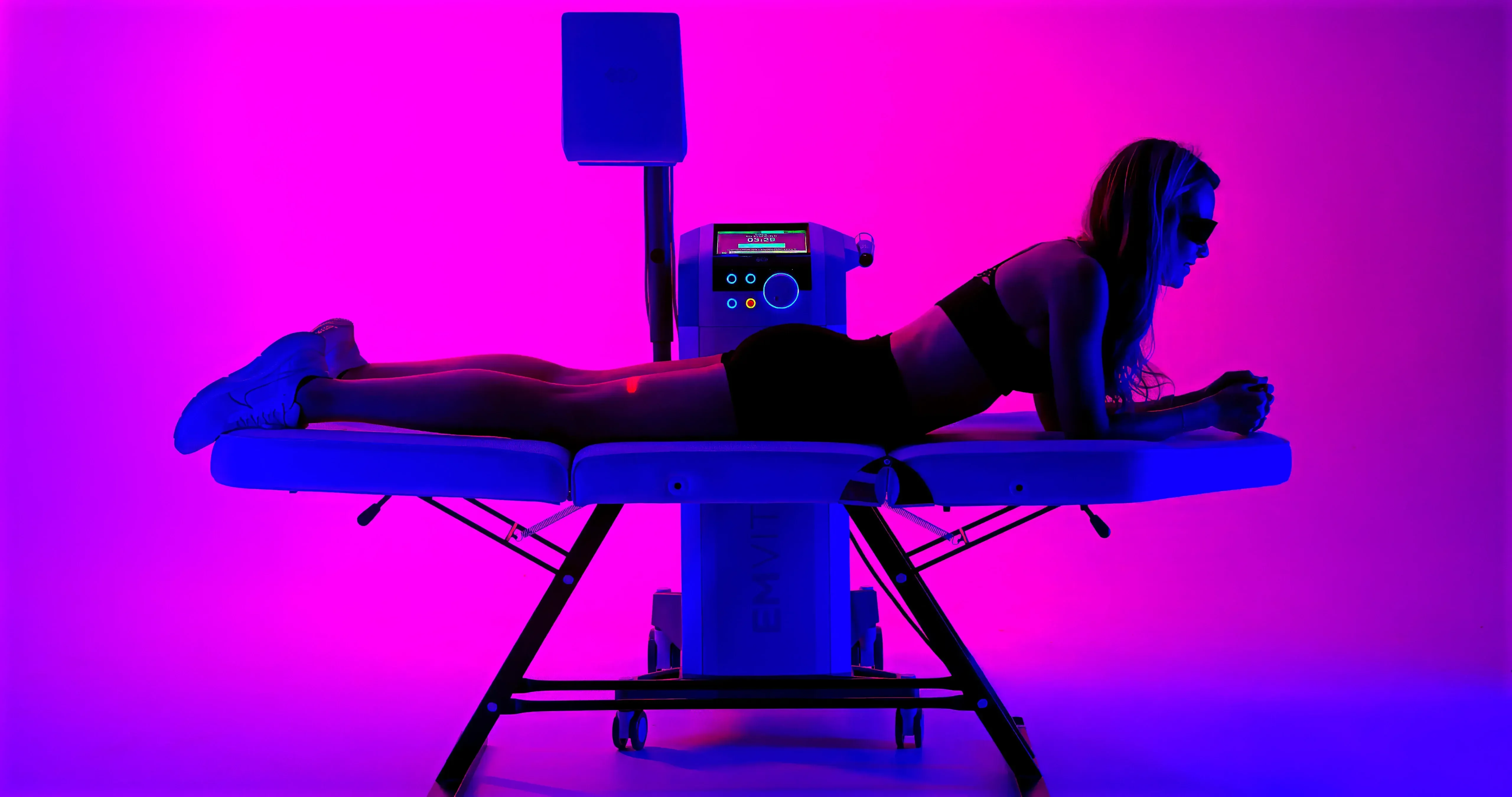 Provider guiding the Emvital laser applicator across a patient's shoulder at Applegate MedSpa in Covington