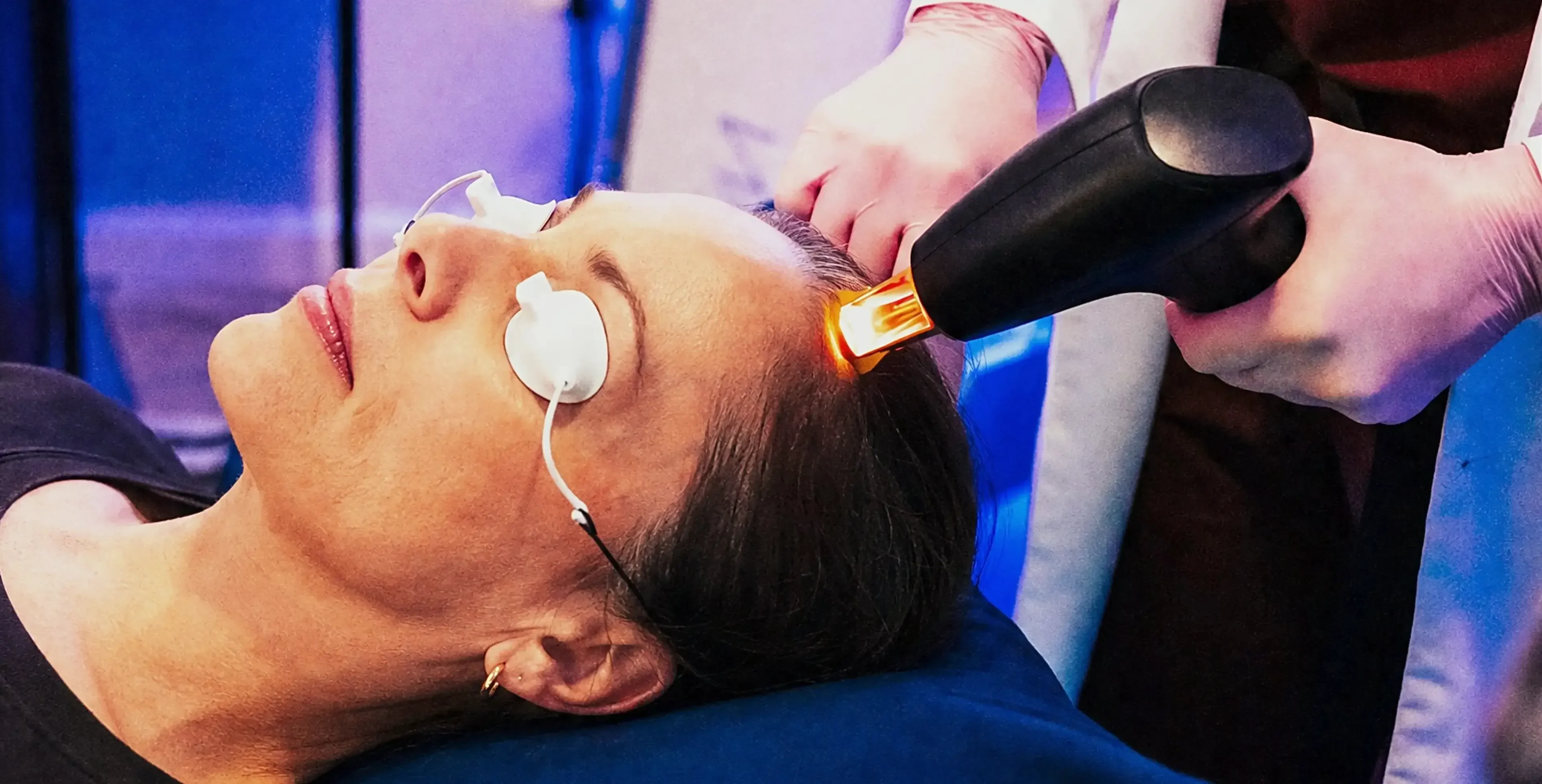 Folix laser array positioned over a patient's scalp during a hair restoration session in Covington, KY