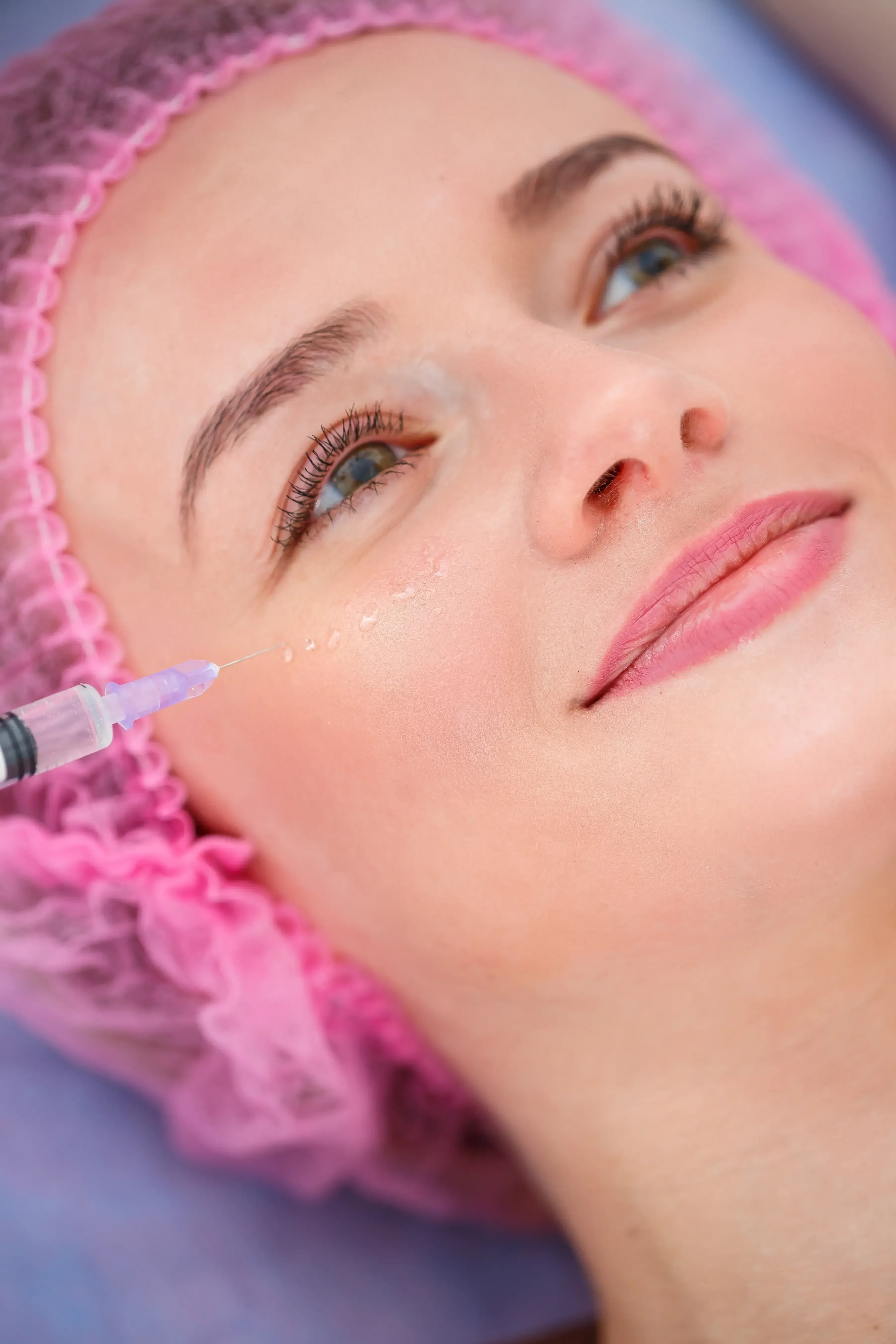 Soft magenta and plum gradient background representing calm, relaxed facial expression after Letybo treatment