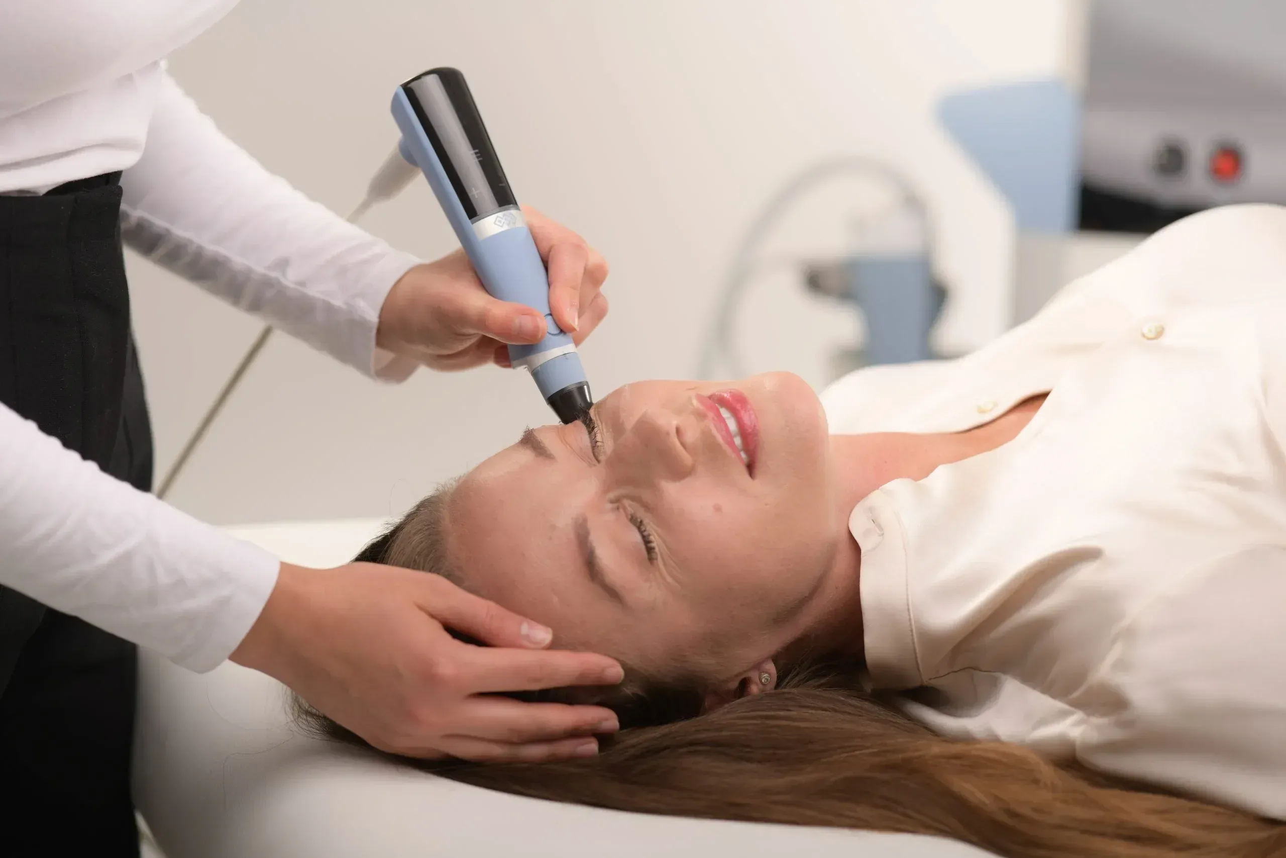 Patient receiving needle free Exion Face skin tightening along the jawline at Applegate MedSpa in Covington, KY